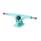 A teal skateboard truck with a curved design and metal bolts.